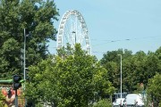 Giant ferris wheel in public park offers panoramic views of the city